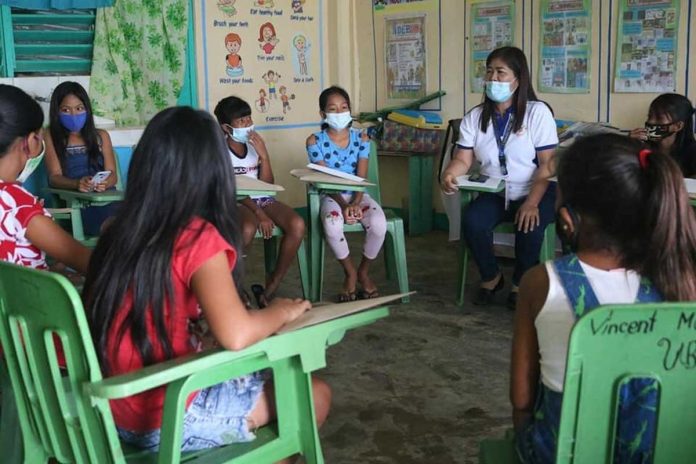 Wearing facemasks, these students gather around their teacher during counseling in this photo from the Department of Education. Starting Jan. 11 next year, authorities will be allowing face-to-face classes in select schools nationwide. DEPED