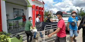 Personnel of the New Tapaz District Hospital in Tapaz, Capiz use a trolley to move one of the bodies of slain suspected rebels on Wednesday. Nine individuals were killed and 17 others were arrested in combined military-police operations in Panay Island on Wednesday. IAN PAUL CORDERO/PN