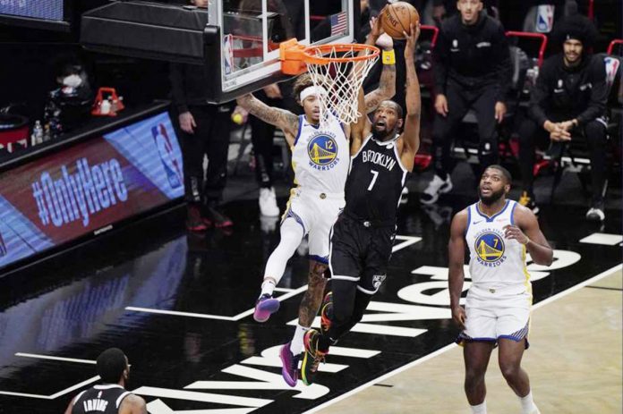 Brooklyn Nets forward Kevin Durant shoots as Golden State Warriors forward Kelly Oubre Jr. defends during the first quarter of an opening night NBA basketball game on Tuesday in New York, United States. PHOTO COURTESY OF KATHY WILLENS/AP