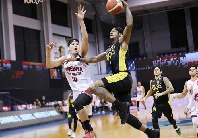 TNT Tropang Giga’s Bobby Ray Parks Jr. attacks the defense of Barangay Ginebra San Miguel Kings’ Arvin Tolentino. PBA PHOTO