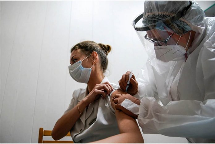 A medic of the regional hospital receives Russia’s “Sputnik-V” vaccine shot against COVID-19 in Tver, Russia. TATYANA MAKEYEVA/REUTERS