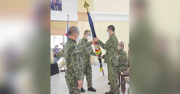 Police Colonel Ramir Perlito Perlas (center), new police director of the Aklan, receives from Police Brigadier General Rolando Miranda(right), Western Visayas police director, the banner of the Aklan Police Provincial Office during the turnover ceremony at Camp Delgado in Iloilo City on Jan. 20, 2021. Looking on is outgoing Aklan police director Police Colonel Esmeraldo Osia. PRO-6 PHOTO