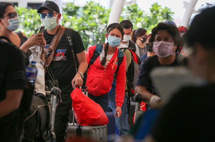 Returning Overseas Filipino Workers (OFW) wait in line at the Ninoy Aquino International Airport (NAIA) Terminal 2 in Pasay City on May 25, 2020. JONATHAN CELLONA/ABS-CBN NEWS