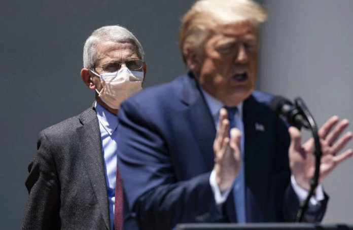 Dr. Anthony Fauci, the nation’s leading infectious disease specialist, looks on as President Donald Trump speaks to reporters at the White House on May 15, 2020. SAMUEL CORUM/THE NEW YORK TIMES