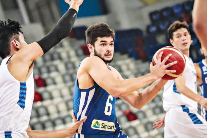 Kobe Paras handles the ball while being defended by a Thailand player during their 2021 FIBA Asia Cup qualifiers match on Nov. 30, 2021 in Manama, Bahrain. FIBA PHOTO