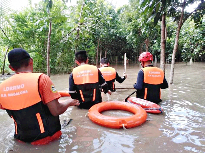 E.B. MAGALONA DRRMO Personnel of the Disaster Risk Reduction and Management Council of E.B. Magalona, Negros Occidental conduct rescue efforts during the Jan. 9 flooding. Thirteen of the town’s 23 villages were submerged to flood waters brought by heavy rains. Mayor Marvin Malacon placed E.B. Magalona under state of calamity.