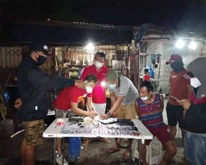 BUSTED Antonio Romero (sits, handcuffed) is the No. 1 in the target list of the Philippine Drug Enforcement Agency (PDEA) Region 6. He yielded suspected shabu weighing about valued at around P800,000 in an entrapment operation in Barangay Tanza Timawa, Iloilo City on Jan. 12.