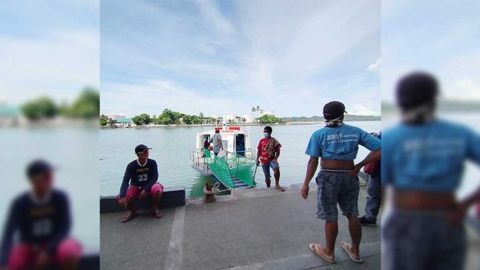 The crew of this Guimaras-bound modernized motorboat docked at the Iloilo Ferry Terminal-Parola in Iloilo City wait for passengers. IAN PAUL CORDERO/PN