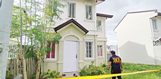 Scene of the crime operatives cordon the front portion of John Michael Brigoli’s house in Barangay Aganan, Pavia, Iloilo on Saturday. Brigoli was believed to have committed suicide. His body was already in the state of decomposition when found by authorities. IAN PAUL CORDERO/PN