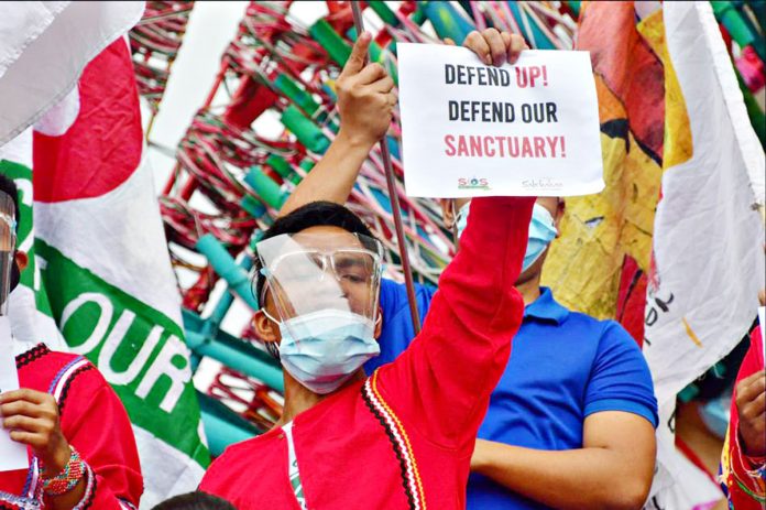 Students attend a protest against the termination of the UP-DND accord prohibiting police and military from entering UP campuses unless with prior notice, at the Quezon Hall in Diliman, Quezon City on Tuesday. MARK DEMAYO/ABS-CBN NEWS