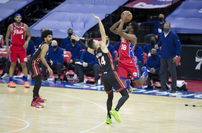 Philadelphia 76ers’ Shake Milton attempts a three-pointer over the defense of Miami Heat’s Tyler Herro. FANSIDED PHOTO