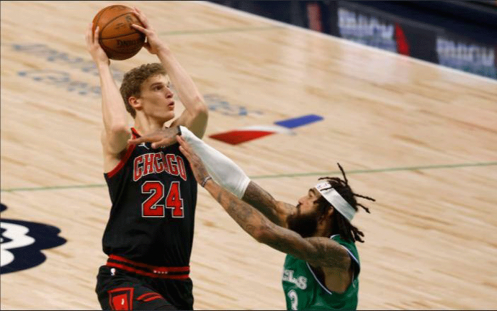 Chicago Bulls forward Lauri Markkanen shoots over Dallas Mavericks center Willie Cauley-Stein during the first half of an NBA basketball game on Jan. 17, 2021. RON JENKINS/AP PHOTO