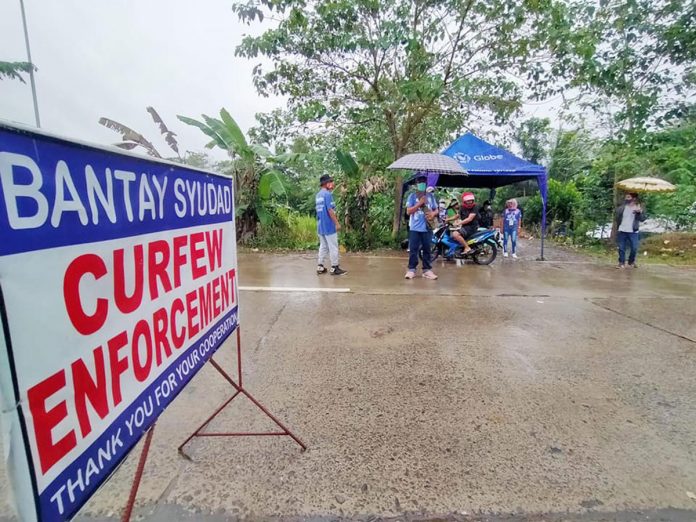 Personnel of the Passi City government man a curfew checkpoint on Friday. Due to surge of coronavirus infections, Passi reverted to enhanced community quarantine for two weeks. CURFEW CHECKPOINT