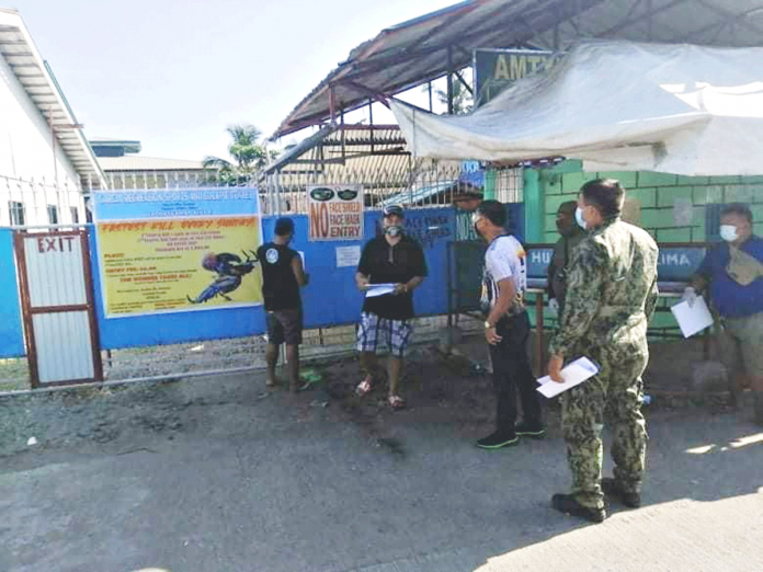 Personnel of the municipal government and police station of Kalibo, Aklan serve a notice of temporary closure to a cockpit in Kalibo, Aklan for disinfection. PHOTO PNP KALIBO