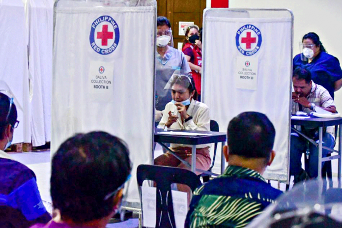 The saliva reverse transcription polymerase chain reaction test pilot at the Philippine Red Cross headquarters in Mandaluyong City on Jan. 12 gets approval from the Department of Health as a new alternative testing method. MARK DEMAYO, ABS-CBN NEWS