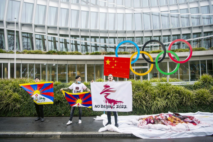 Protesters carry Tibetan flags during a protest against Beijing 2022 Winter Olympics because of reported human rights abuse. AP