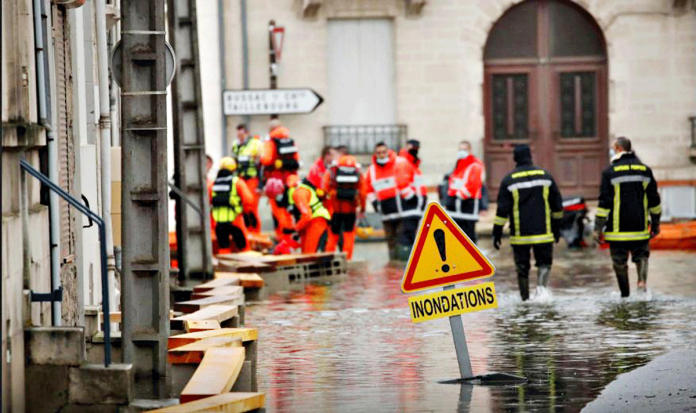 Rescue workers help residents in flooded areas as the Charente River overflows after days of rainy weather causing flood in western France, on Feb. 8, 2021. REUTERS