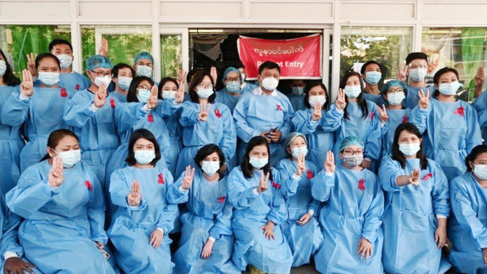 Medics in Yangon General Hospital wear red ribbons as a sign of protest. REUTERS