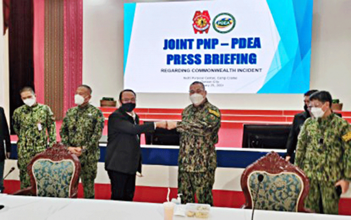 Philippine National Police chief Gen. Debold Sinas (2nd from right) and Philippine Drug Enforcement Agency director general Wilkins Villanueva (3rd from left) do a fist bump during a joint press briefing in Camp Crame, Quezon City on Thursday. PNA PHOTO BY LLOYD CALIWAN