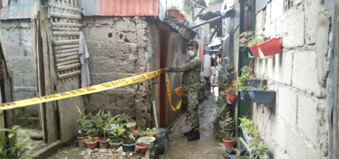 A man died while his live-in partner was wounded in a shooting incident. An officer of Police Station 2 cordons the crime scene in Purok Sigay, Barangay 2, Bacolod City on Feb. 16. POLICE STATION 2/BCPO