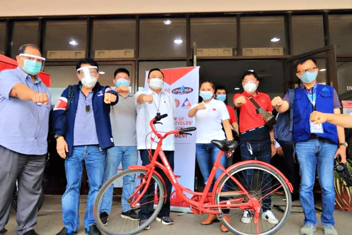 (From left) Budget secretary Wendel Avisado, Labor secretary Silvestre Bello III, Miguel Treñas with his father Mayor Jerry Treñas, Cong. Julienne Baronda, also with his father, former Iloilo City Health Officer Dr. Urminico Baronda, and Undersecretary Hans Leo Cacdac of the Overseas Workers Welfare Administration pose with a fist bump during the ceremonial turnover of Japanese bikes for frontliners in Iloilo City.