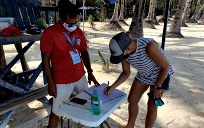 A tourist registers at the lifeguard station before swimming in the waters of Boracay Island. PNA/ YES THE BEST BORACAY