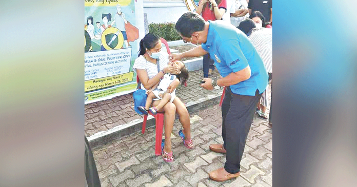 A CHILD receives oral polio vaccine during the kickoff of the Measles-Rubella Oral Polio Vaccine Supplemental Immunization Activity in Jordan, Guimaras. JORDAN LGU PHOTO