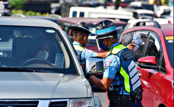 Enforcers from the Land Transportation Office give leaflets along Quezon Avenue in Quezon City. This is accordance with the implementation of the Child Safety in Motor Vehicles Act or Republic Act No. 11229 which took effect on Tuesday. ABS-CBN NEWS