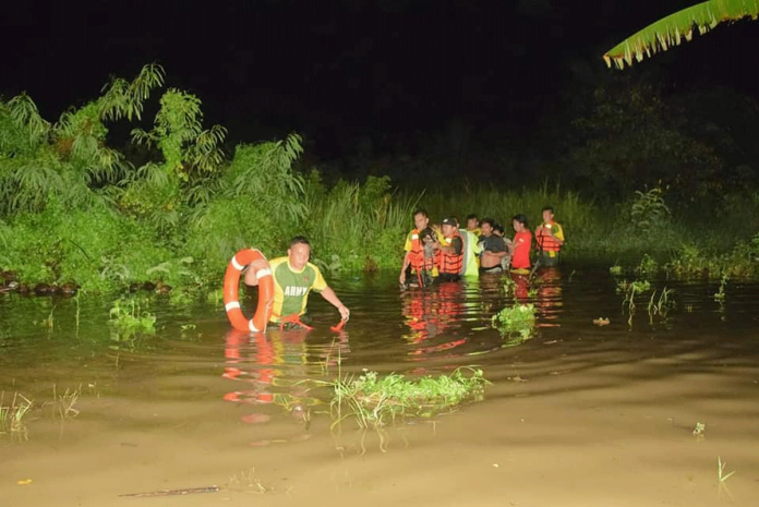 Philippine Army soldiers rescue residents of a flood-hit barangay in San Carlos City, Negros Occidental on the night of Feb. 14.. SAN CARLOS DRRMO