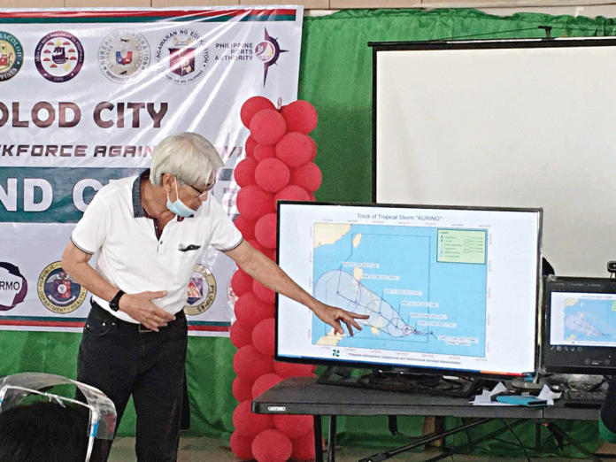 Bacolod City disaster management chief Jose Maria Vargas points to the forecast track of Tropical Storm “Auring.” The weather disturbance may pass some areas in Western Visayas. BACOLOD CITY DRRMO