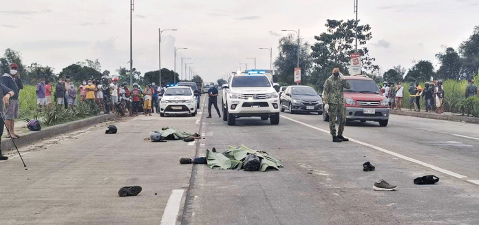 TRAGIC DEMISE. Covered with banana leaves, the bodies of Allan Bedonia and his nephew Rodrigo lay cold in Barangay Efigenio Lizares, Talisay City, Negros Occidental. They were onboard a motorcycle when sideswiped by a prime mover truck on Feb. 13. CDRRMO TALISAY CITY