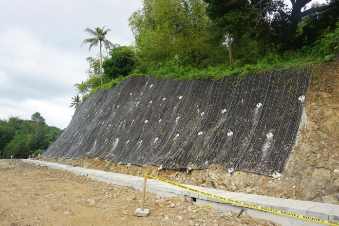 This slope protection structure uses high tensile wire. It is being implemented by the Guimaras District Engineering Office along the Guimaras Circumferential Road, Barangay Igdarapdap, Nueva Valencia, Guimaras. PHOTO COURTESY OF DPWH GUIMARAS DEO