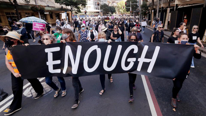 Protesters with placards and banners rally around Australia on March 15, 2021 to demand justice for women. AP