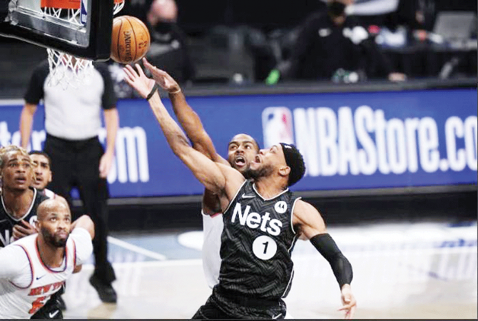 Brooklyn Nets guard Bruce Brown (1) drives past the defense of New York Knicks’ Alec Burks (back) during their 2020-2021 NBA Season encounter on Monday night at the Barclays Center in Brooklyn, New York. FRANK FRANKLIN II/AP