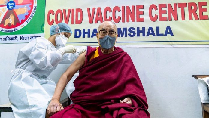 A healthcare worker injects a coronavirus disease 2019 vaccine at Tibetan spiritual leader, the Dalai Lama. EPA