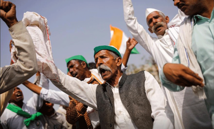 Farmers dance as they sing a folk song during a 12-hour strike, as part of protests against farm laws, on a highway at the Delhi-Uttar Pradesh border in Ghaziabad, India. REUTERS/ADNAN ABIDI