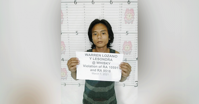 Warren Lozano, 26, a suspected member of the New People’s Army, was arrested in a joint police and military operation in Barangay Caradio-an, Himamaylan City, Negros Occidental on March 1. HIMAMAYLAN CITY PNP