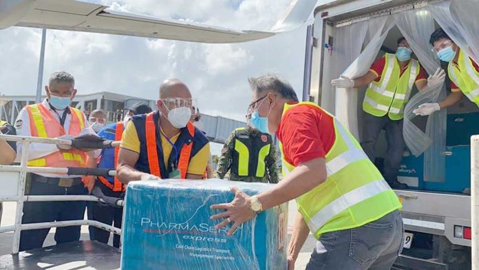 SINOVAC’S ARRIVAL. Cold chain and logistics personnel of the Western Visayas’ Vaccination Operations Center facilitate the offloading of Sinovac vaccines at the Iloilo International Airport in Cabatuan town. These vaccines are intended for four COVID-19 referral hospitals in Iloilo. PHOTO BY OCD-6