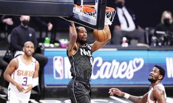 Brooklyn Nets forward Kevin Durant (7) stuns Phoenix Suns with a dunk during the third quarter of their basketball game on Sunday, April 25, in New York. AP PHOTO/KATHY WILLENS