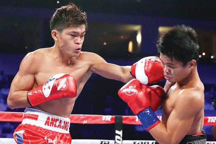 Jerwin Ancajas (left) lands a punch against fellow Filipino fighter Jonas Sultan (right) during their world title clash in 2018. This weekend, Ancajas will defend his IBF World super-flyweight title against Mexican Jonathan Rodriguez. TOP RANK PHOTO