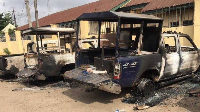 Burnt-out vehicles were seen outside the jail in Imo state, Nigeria after an explosion. Nigerian Correctional Service said that 1,844 inmates escaped the jail. BBC