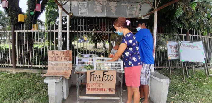 A woman avails herself of vegetables displayed at a community pantry in New Lucena, Iloilo. This initiative has spread throughout the country, but some of its organizers were reportedly “red-tagged” by the police. On Tuesday, the Palace said “red-taggers” should not interfere with the works of the community pantries. PANAY NEWS PHOTO