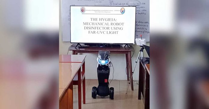 Senior high school students of the University of Perpetual Help in Roxas City present their invention – a robot disinfector. PHOTOS FROM ‘UPOD KITA RONNIE DADIVAS’ FACEBOOK PAGE