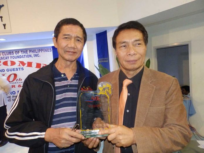 Former Panay News editor-in-chief and now columnist Herbert Vego is holding an award with Panay News late founder Daniel Fajardo. PN FILE PHOTO