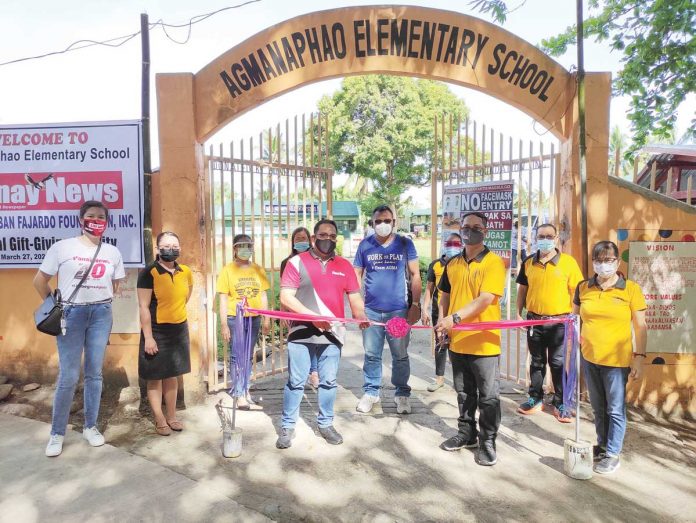 Daniel S. Fajardo II (third from left), one of the Board of Directors of Panay News Inc., Ian Paul Edang (second from right), teacher-in-charge of Agmanaphao Elementary School, and Allan Torres (center), barangay chairman of Agmanaphao, Mina, Iloilo lead the ribbon-cutting ceremony on March 27, 2021. AES GETS NEW GATE