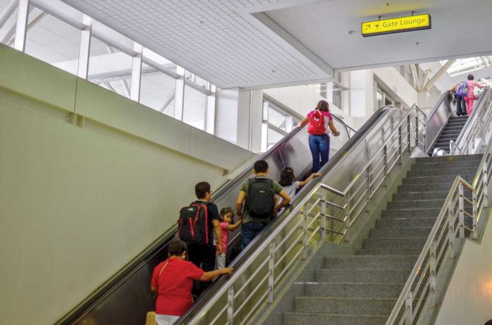 Airline passengers take the escalator to go to the airport lounge of the Iloilo International Airport in Cabatuan, Iloilo. Due to the continuous increase of coronavirus disease 2019 cases, the country has extended the travel ban on foreigners until April 30. PANAY NEWS PHOTO