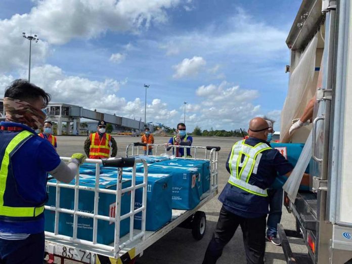 Workers unload boxes that contain jabs against coronavirus disease 2019 from an aircraft at Iloilo International Airport in Cabatuan, Iloilo on March 30. Starting next month, Vaccine Czar Carlito Galvez Jr. says the country will expect an accelerated delivery of vaccines. JERRY TREÑAS/FACEBOOK