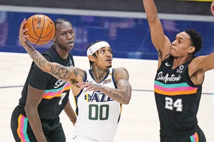 Filipino American guard Jordan Clarkson of Utah Jazz (00) drives for a basket against San Antonio Spurs’ Devin Vassell (24) during the second half of their basketball game on Wednesday. AP PHOTO/RICK BOWMER