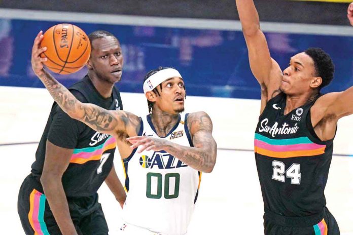 Utah Jazz’s Jordan Clarkson (center) wins NBA’s Sixth Man of the Year award for the 2020-2021 season. RICK BOWMER