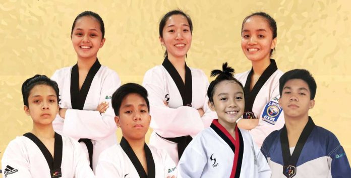 Taekwondo jins from A. Diasnes Gym (first row from left) Elisha Aguilar, Elaine Margaret Borres, and Elizabeth Marie Borres, (second row from left) Seth Ryan Templanza, Antonio Miguel Nafarrete, Kian Ezekiel Castigador, and Janus Miguel Tacsagon harvest medals in the recently held 2021 Online West Coast International Taekwondo Championships. A. DIASNES TAEKWONDO GYM